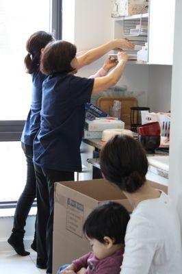 Packing plates into a moving box in the kitchen, with meticulous attention to detail.