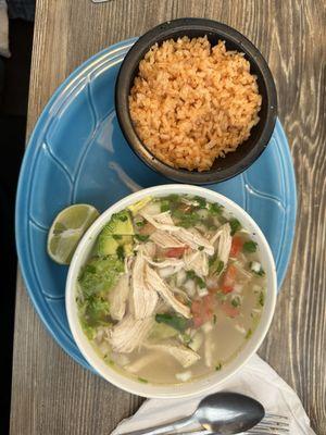 Chicken soup with rice on the side.