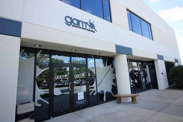 The GAM front entrance, complete with a metal sign of our logo in addition to a large series of decals across all of our exterior windows.