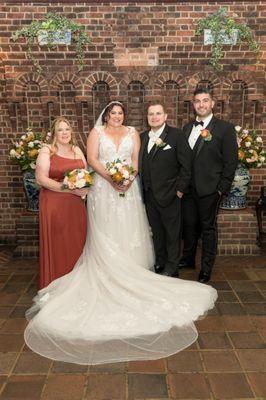 Our wedding party with our bouquets/arrangements that have the ugly yellow/brown mums. Our best man got the terracotta rose we agreed on.