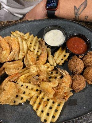 Fried jumbo shrimp with waffle fries and hush puppies