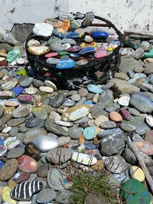 Painted rocks. Many people have left thier mark by painting a rock and placing it near the Lighhouse. Cute tradition.