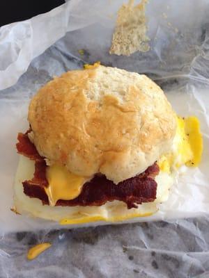 A delicious bacon, egg, and cheese biscuit sandwich.