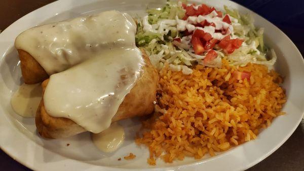 Chicken chimichanga with a delicious cheese sauce