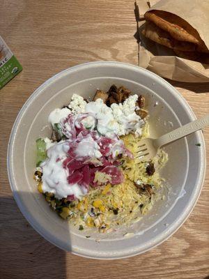 Bowl with rice, chicken, cucumber, corn, feta, and garlic dressing