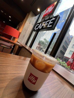 Iced Americano with a Denver backdrop