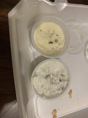 Cup of mayonnaise on top and a cup of tzakziki sauce on bottom.