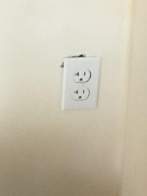 one of two outlets with poorly cut sheetrock