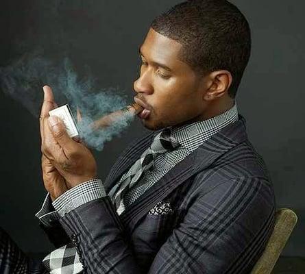 Usher enjoys a cigar