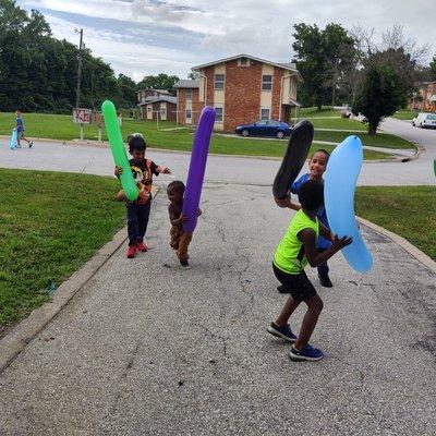 Kids having fun fighting with big balloons