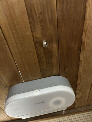 Peepholes in the stalls