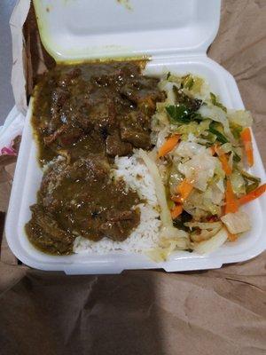 Curry goat with white rice and steamed vegetables