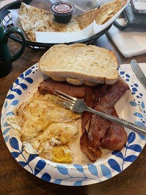 Eggs, bacon, ham, toast, and coffee all 100% superb