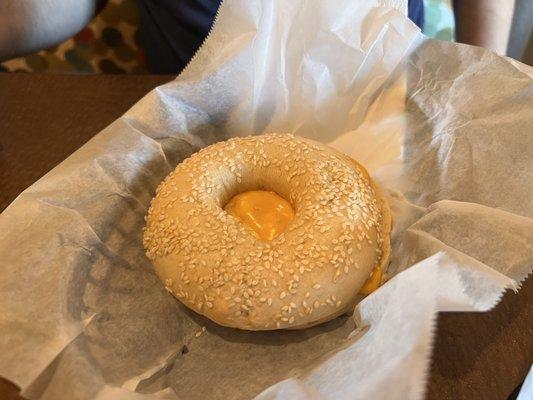 Sesame bagel with cheese and egg