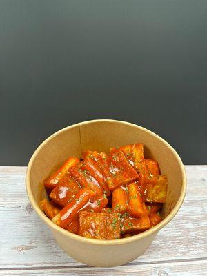 Tteokboki

Chewy rice cake with umami fish cake in secret spicy sauce. 
Try with cheese bomb($2)