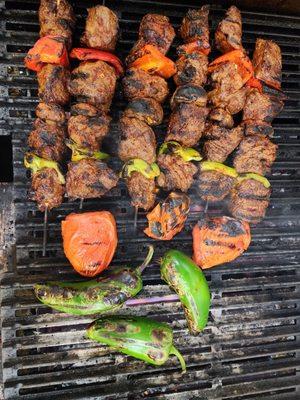 Beef skewers and grilled tomatoes and jalapeños