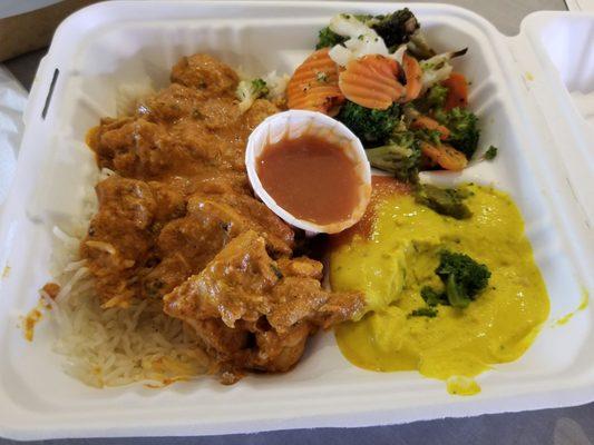 Butter chicken, coconut rice, veggies and hummus.