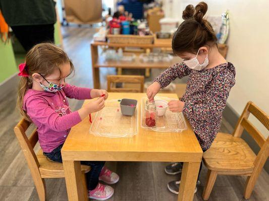 Children working on practical life Montessori work