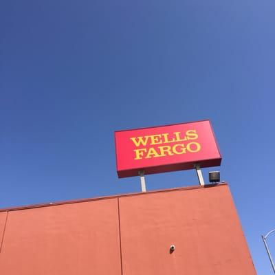 Wells Fargo signage against a beautiful Spring day sky.