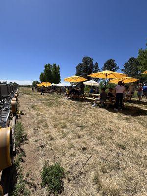 The turnaround poon with picnic tables and umbrellas.