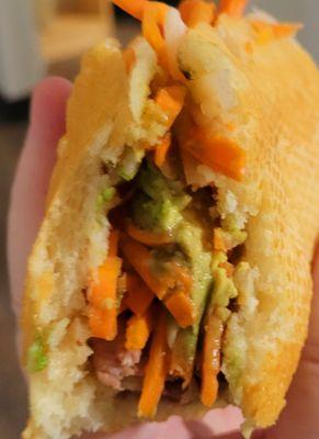 Inside the grilled pork add  avocado banh mi.