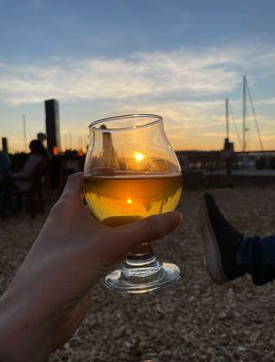 Sunset from the outdoor seating area with a delicious hard cider from the tap