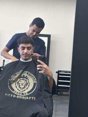 Me having  haircut with my barber Murad