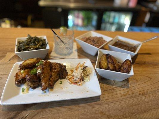 Habanero Wings, collard greens, fried plantains, oxtail gravy, rice & peas (clockwise from bottom right).