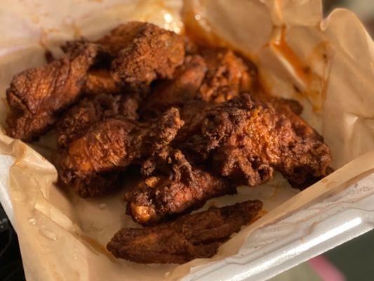 Fried chicken wings in Buffalo spicy sauce