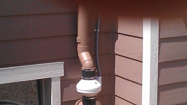 Radon Mitigation System Exterior Install Painted to Match Home