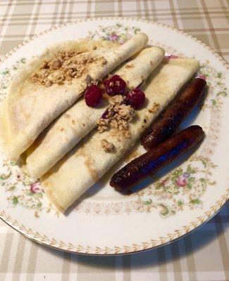 Raspberry creme-filled crepes with granola and fresh berries