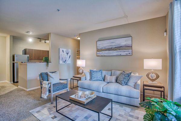 a living room with a couch and a table at Spring Creek Apartments