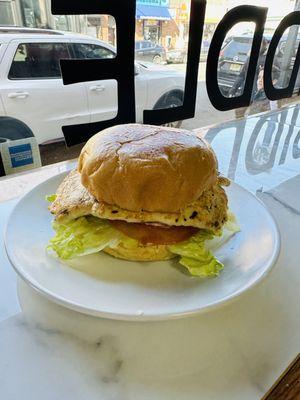 Lemon and Garlic marinated Grilled Chicken on a brioche bun with mayo, lettuce, and tomatoes