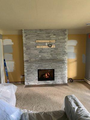 Regency P33CE with Indiana Limestone mantel. Clarois Silver stack stone from the tile shop.