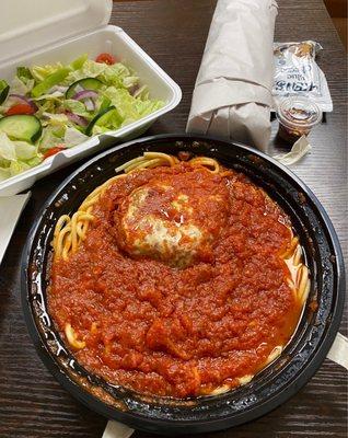 Chicken Parmigiana - over spaghetti. Salad and garlic bread included. Chicken is a small portion.