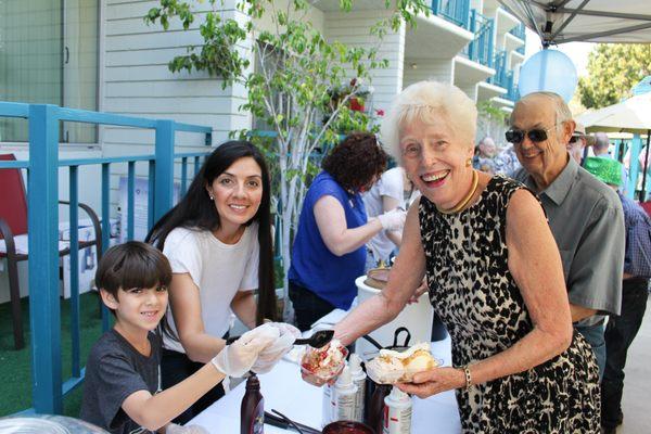 Volunteers help serve ice cream to St. Paul's Manor and St. Paul's Villa residents during ice cream social.