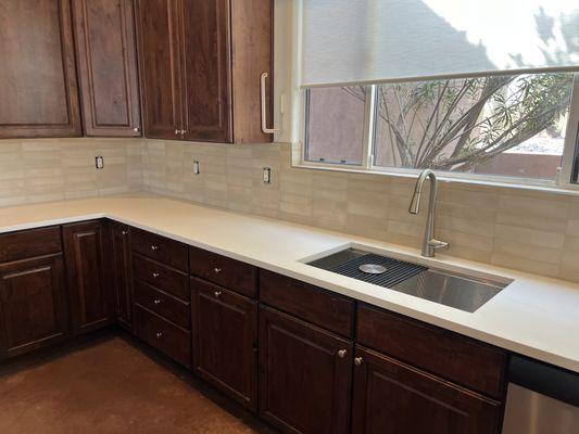 A new quartz countertop paired with a stylish porcelain backsplash.