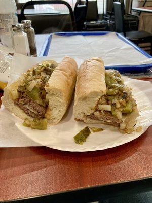 Large Cheeseburger Sub with Grilled Peppers and Onions on a Fresh Untoasted Roll.