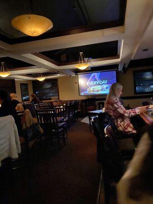 Bar area with large screen for sports.