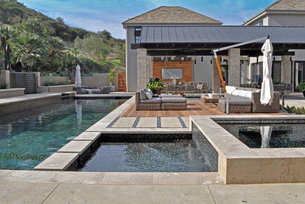 Geometric Pool with floating steps, an elevated spa, and tanning ledge