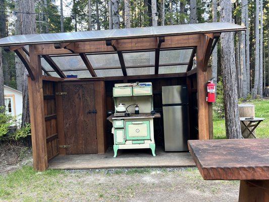 Outdoor kitchen. Bring propane per info. There is a small shared refrigerator.