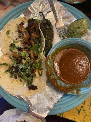 Tacos Al pastor with a side of Chile Colorado sauce. Spicy goodness!!