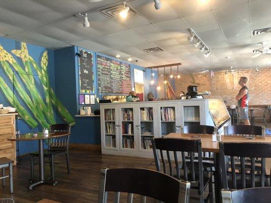 Colorful menu board, homey dining area.