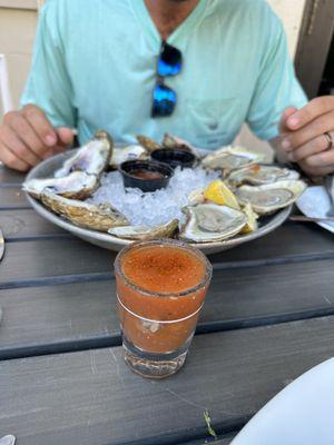 Oyster shooter and raw oysters.