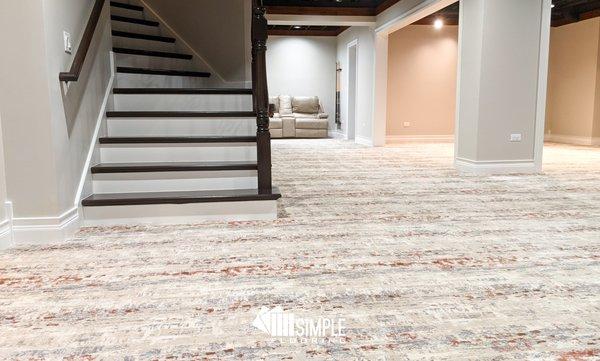 Luxury carpet and hardwood stairs installed in a basement