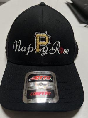 Black Embroidered ball cap with white, yellow and red writing that reads Nappy Rose