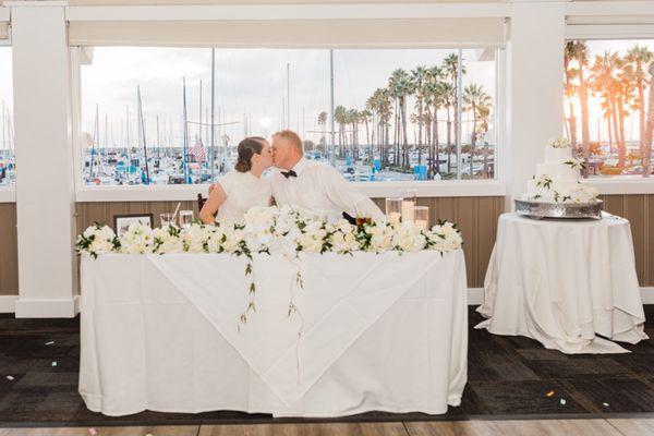 sweetheart table florals, featuring hanging vines for wedding reception at Bluewater Grill, Newport Beach