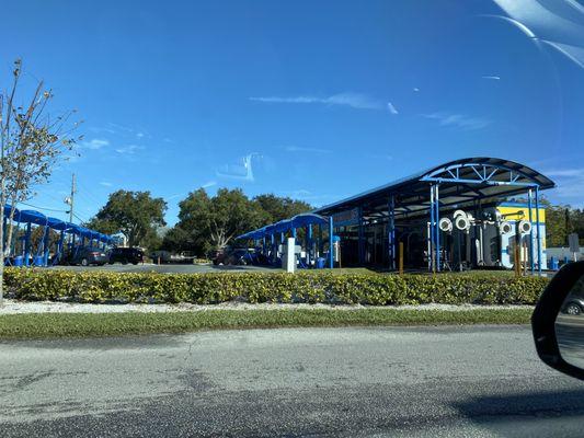 The car wash from the access road by the Mobile gas station.