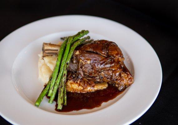 Braised local lamb shank, buttermilk mashed potatoes, grilled asparagus, and smoked shallot demi glaze