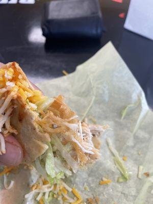 That yellow hard part? That's not cheese or shell, that's the chicken.